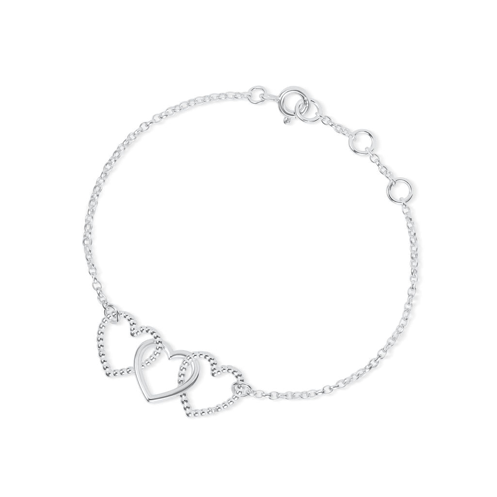 A delicate silver chain Cariad bracelet by Elin Mair featuring two interlocking open heart charms, one with a textured beaded outline and one smooth, on a clean white background.