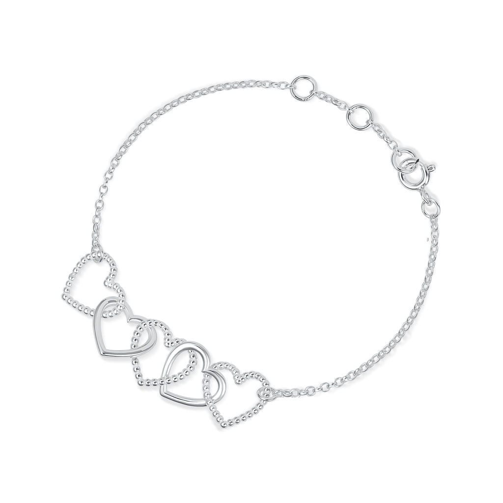 A delicate silver chain Cariad bracelet by Elin Mair featuring four interlocking open heart charms, photographed on a clean white background.